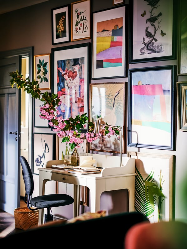 A bold interior with lots of colour and a vase with pink flowers.