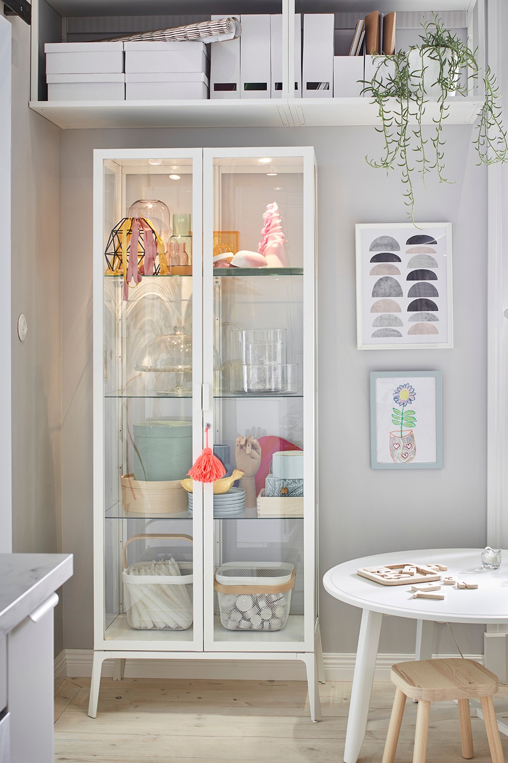 A white MILSBO glass-door cabinet