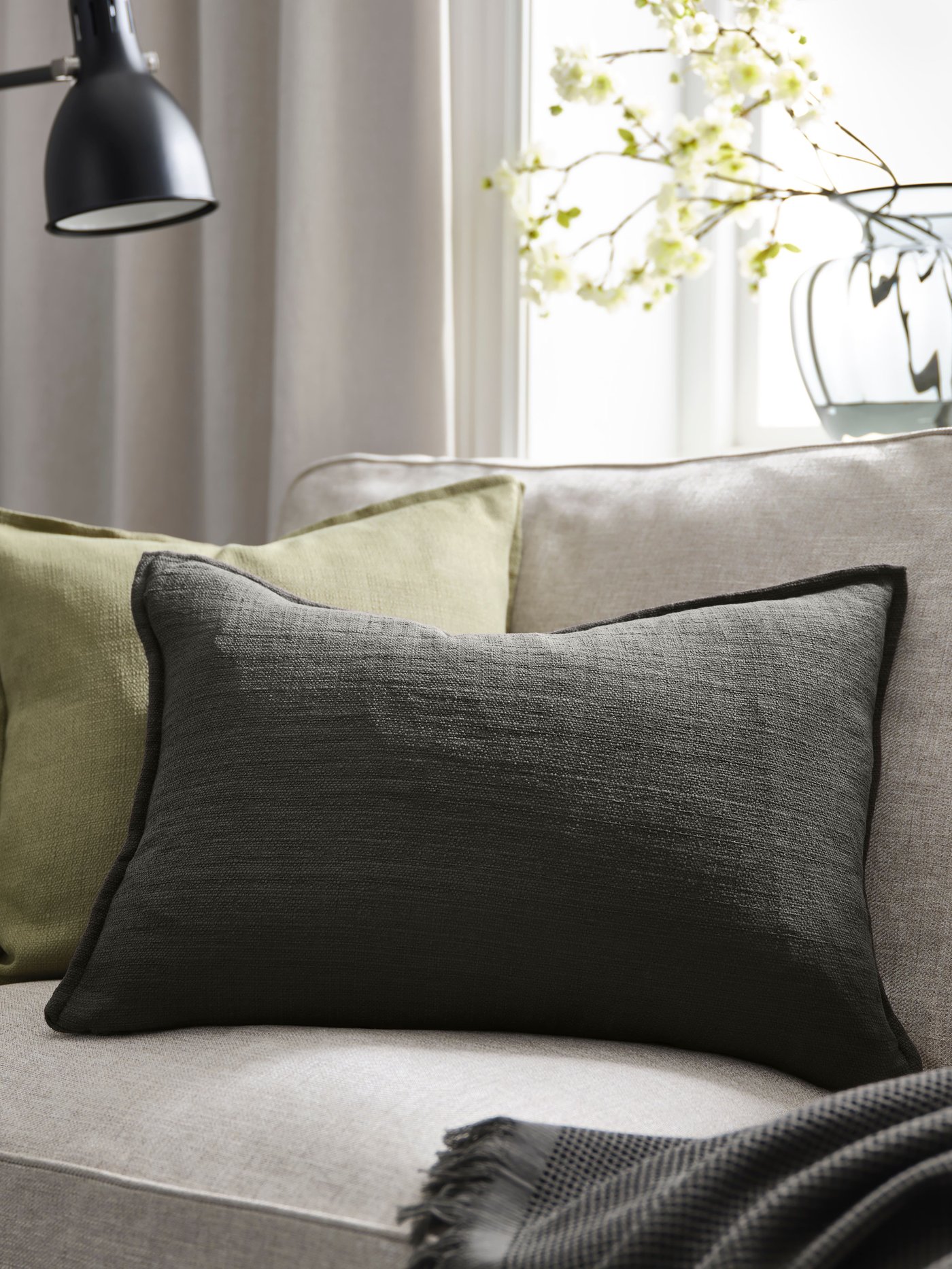 An anthracite LAGERPOPPEL cushion cover