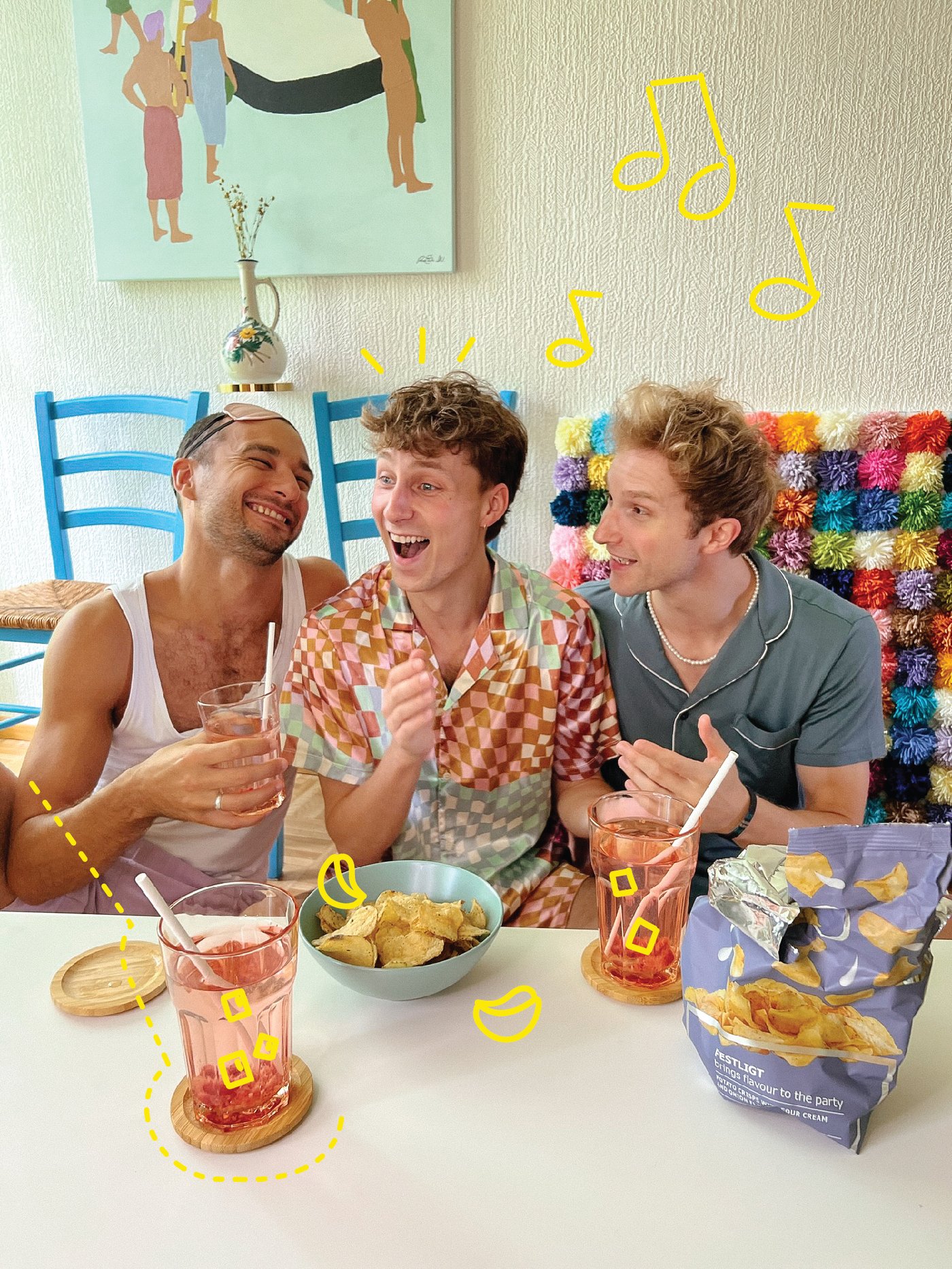 A group of friends sitting around a coffee table full of snacks and drinks.