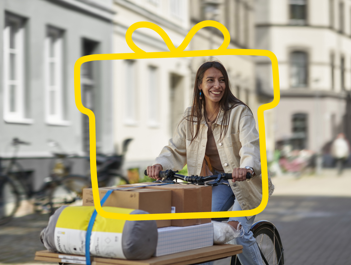 A woman on her bike with various packages.