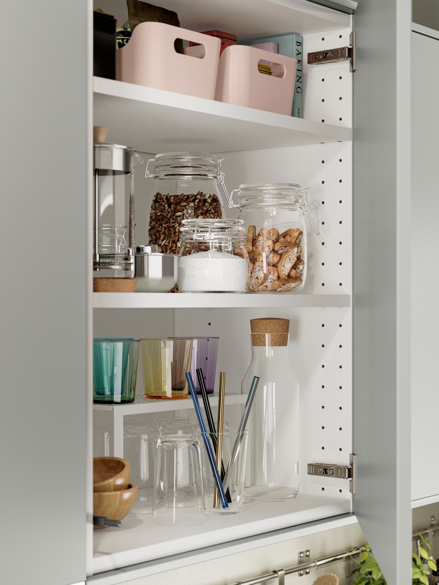 A kitchen cabinet with HAVSTORP light grey fronts, with glass jars filled with food items and a row of drinking glasses.