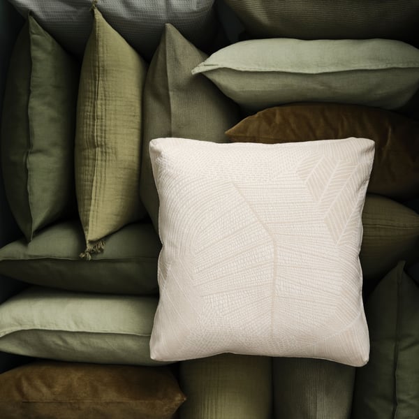A grey-green VALLKRASSING cushion cover