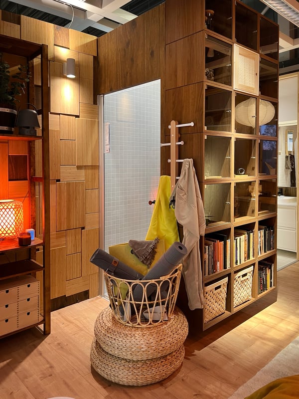 An en-suite bathroom with wooden walls on the outside with storage and a basket of things