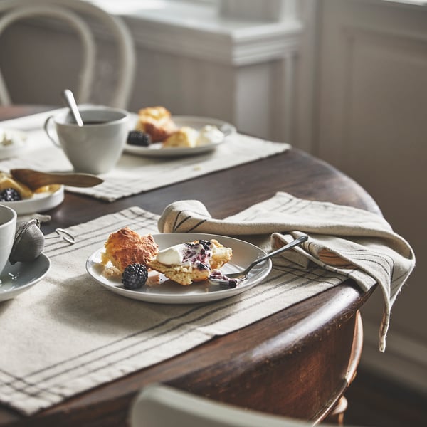 A dark grey/natural VÅRARV place mat