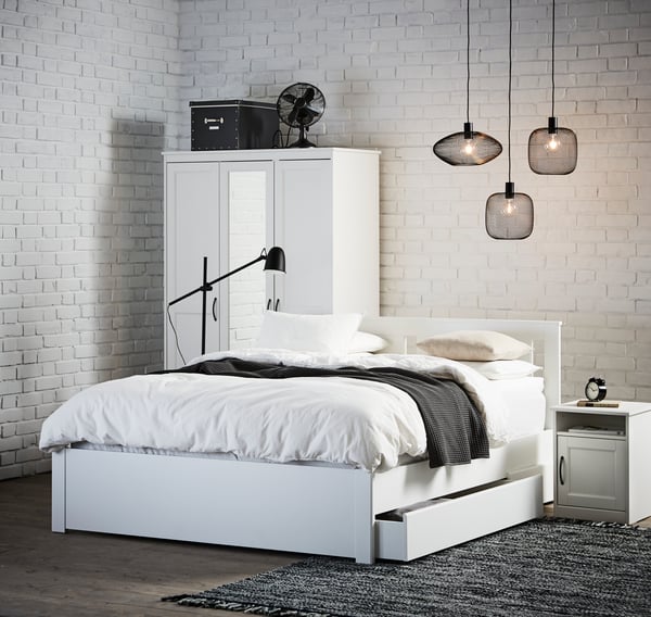A black SKURUP floor/reading lamp in the bedroom