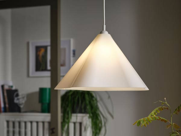 A white/plastic ZEBRASÄV pendant lamp in the dining room