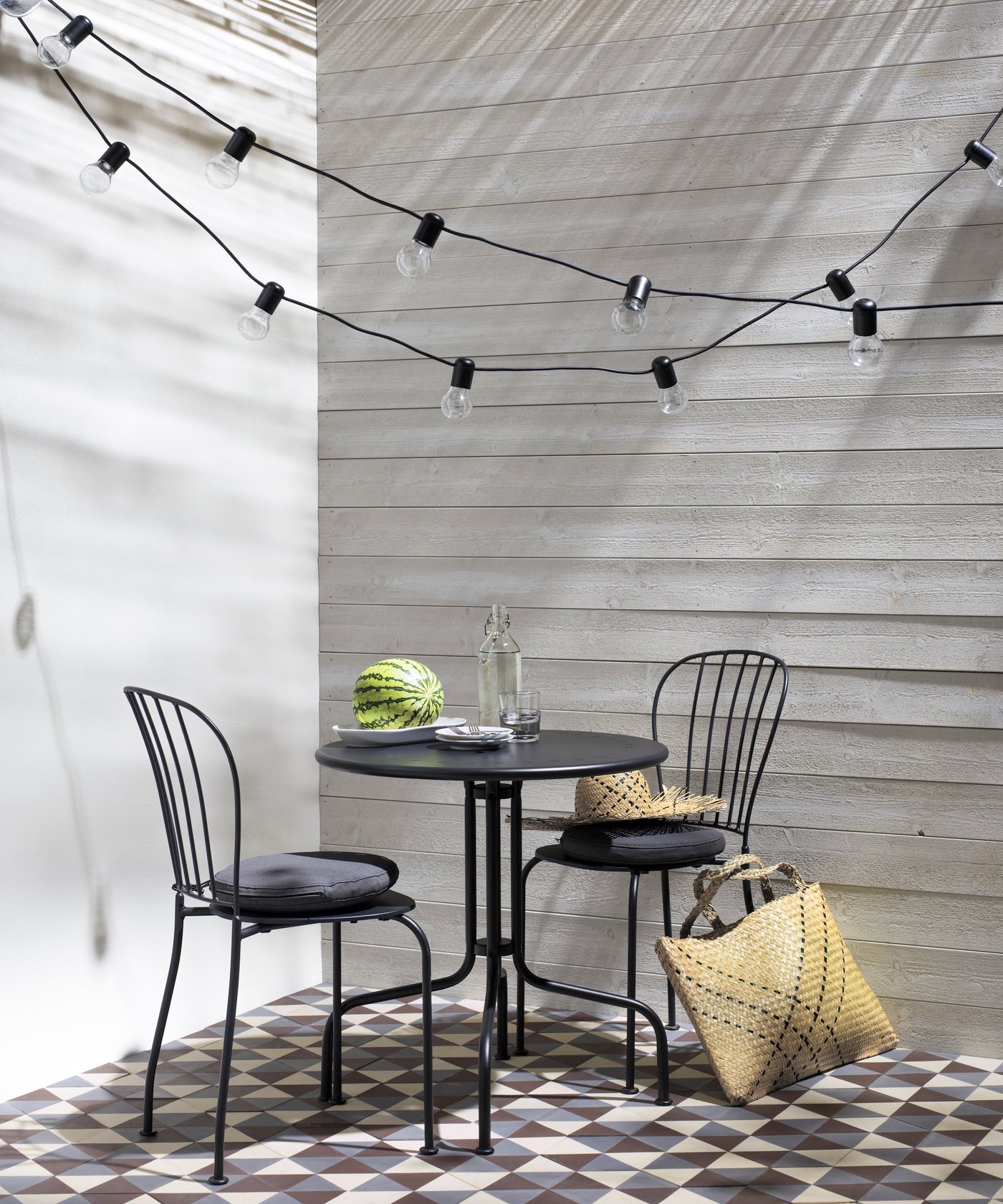 A clear glass KORKEN bottle with stopper outside