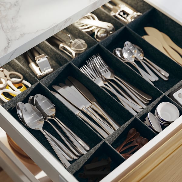 A stainless steel MARTORP 30-piece cutlery set in the kitchen