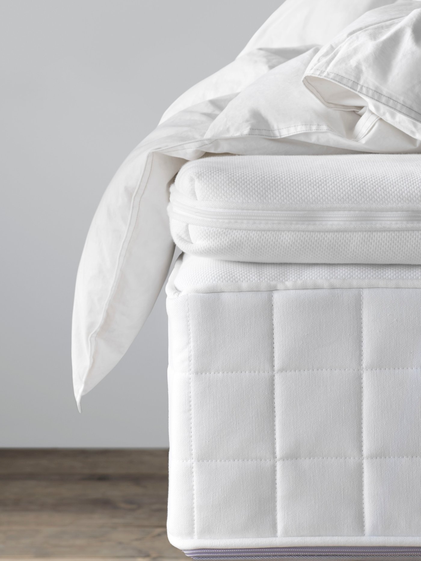 a white mattress topper on top of a mattress