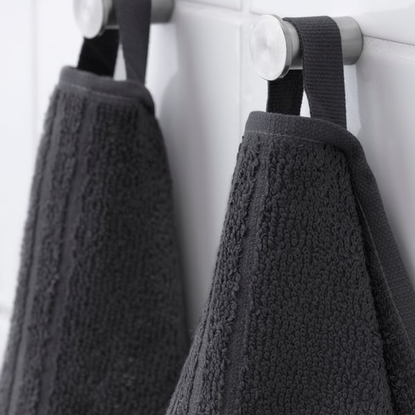 A dark grey VÅGSJÖN hand towel in the bathroom