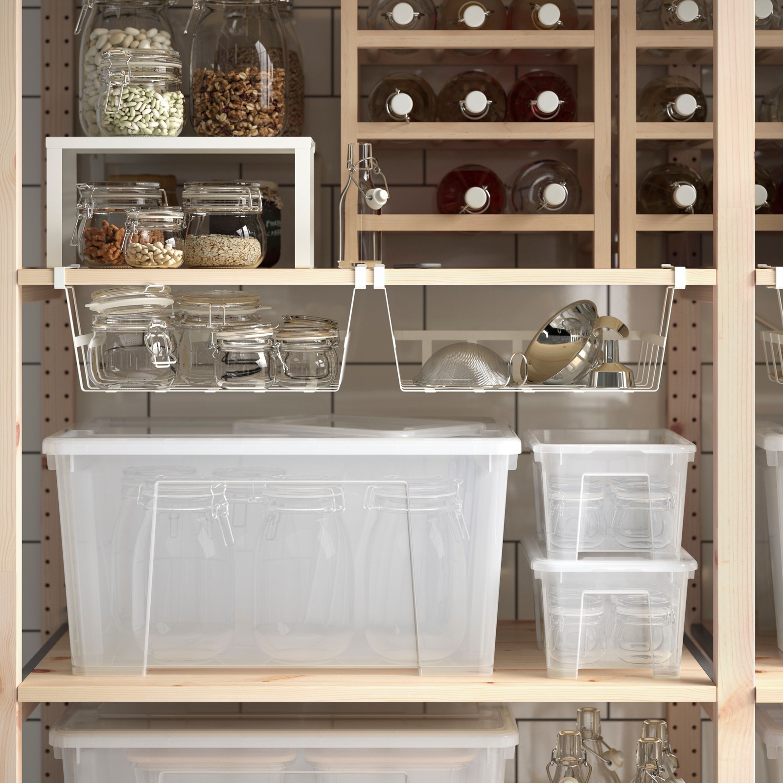 A section of an IVAR shelving unit with preserves and dry goods in bottles and jars, some of which are held in SAMLA boxes.