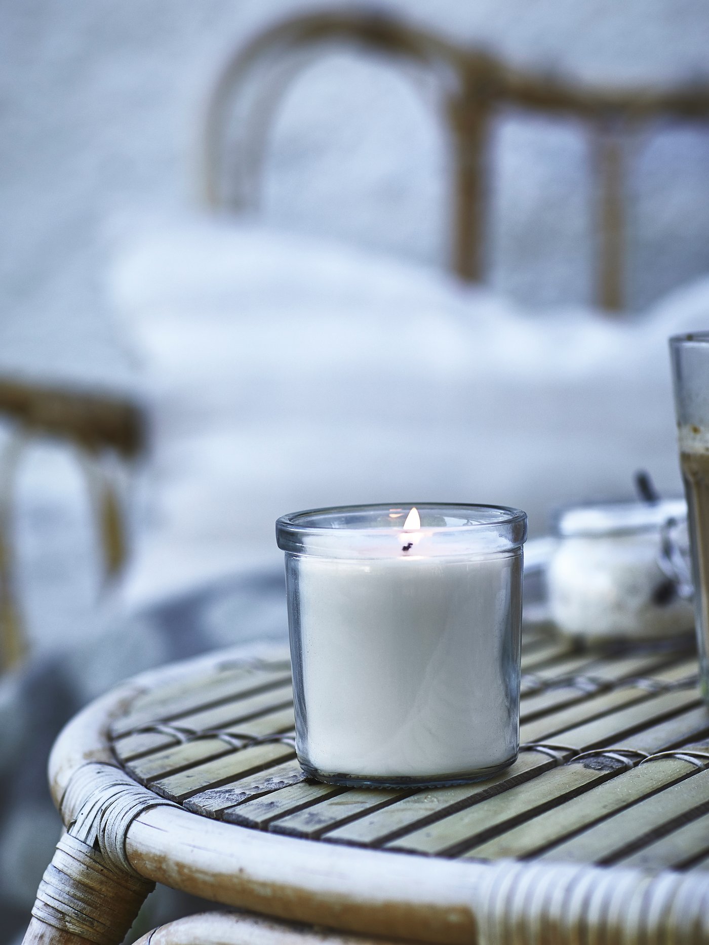 A Vanilla/light beige JÄMLIK scented candle in glass