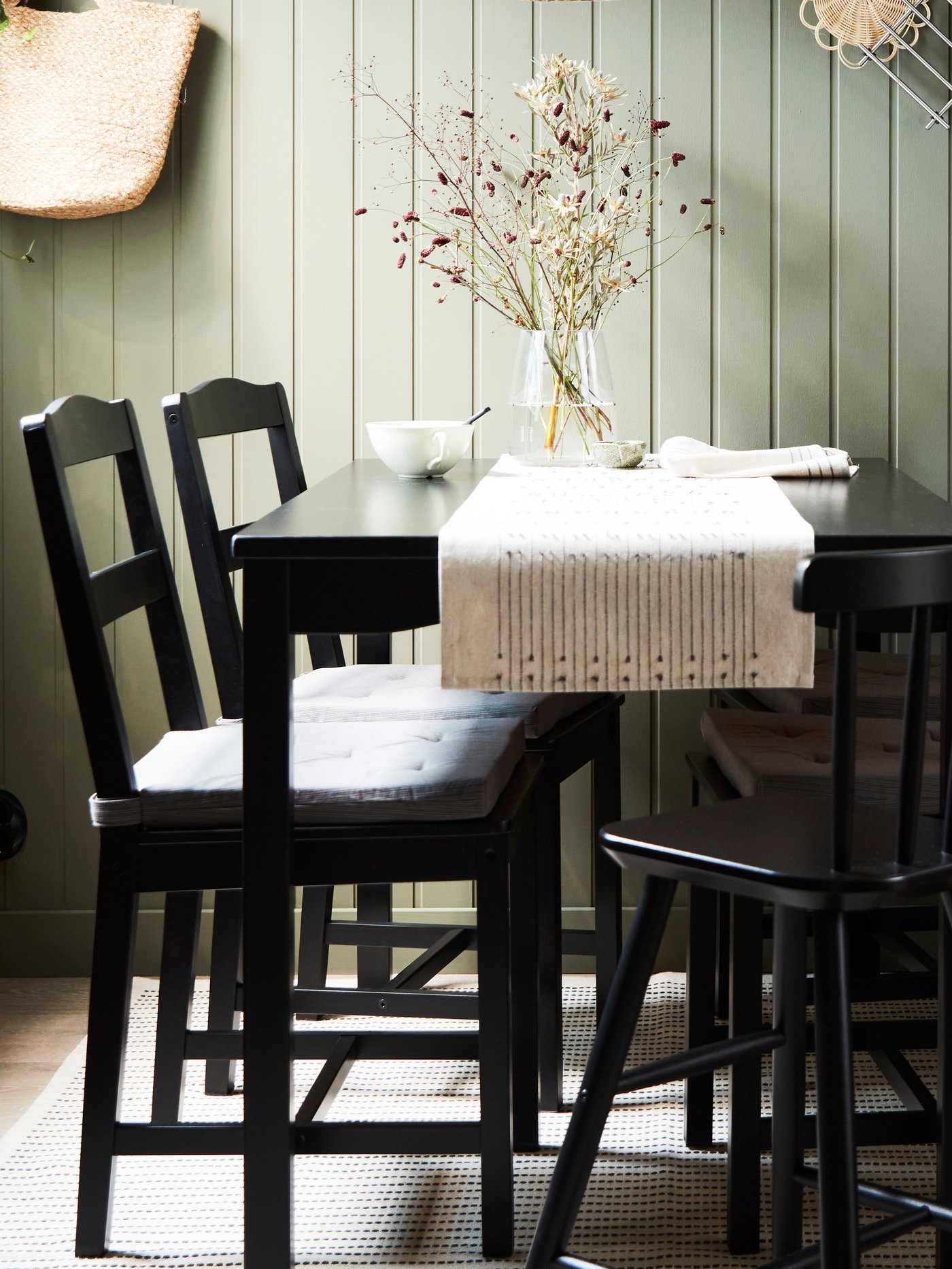 A black stained pine HÄGERNÄS table and 4 chairs