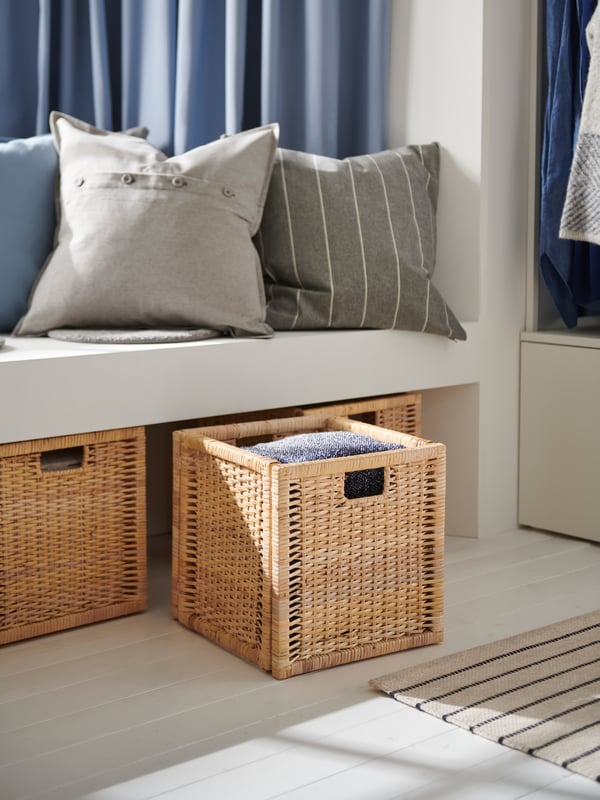 A rattan BRANÄS basket in the hallway