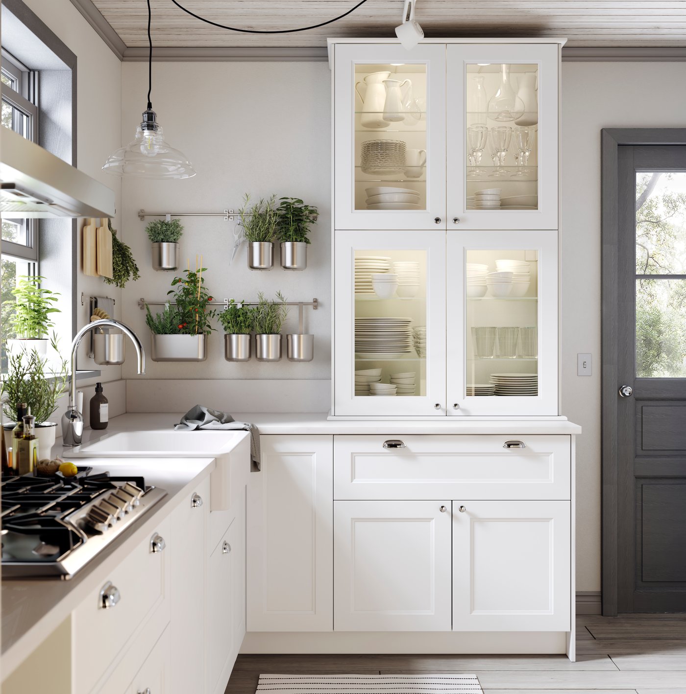 A brightly lit kitchen with white kitchen cabinets.