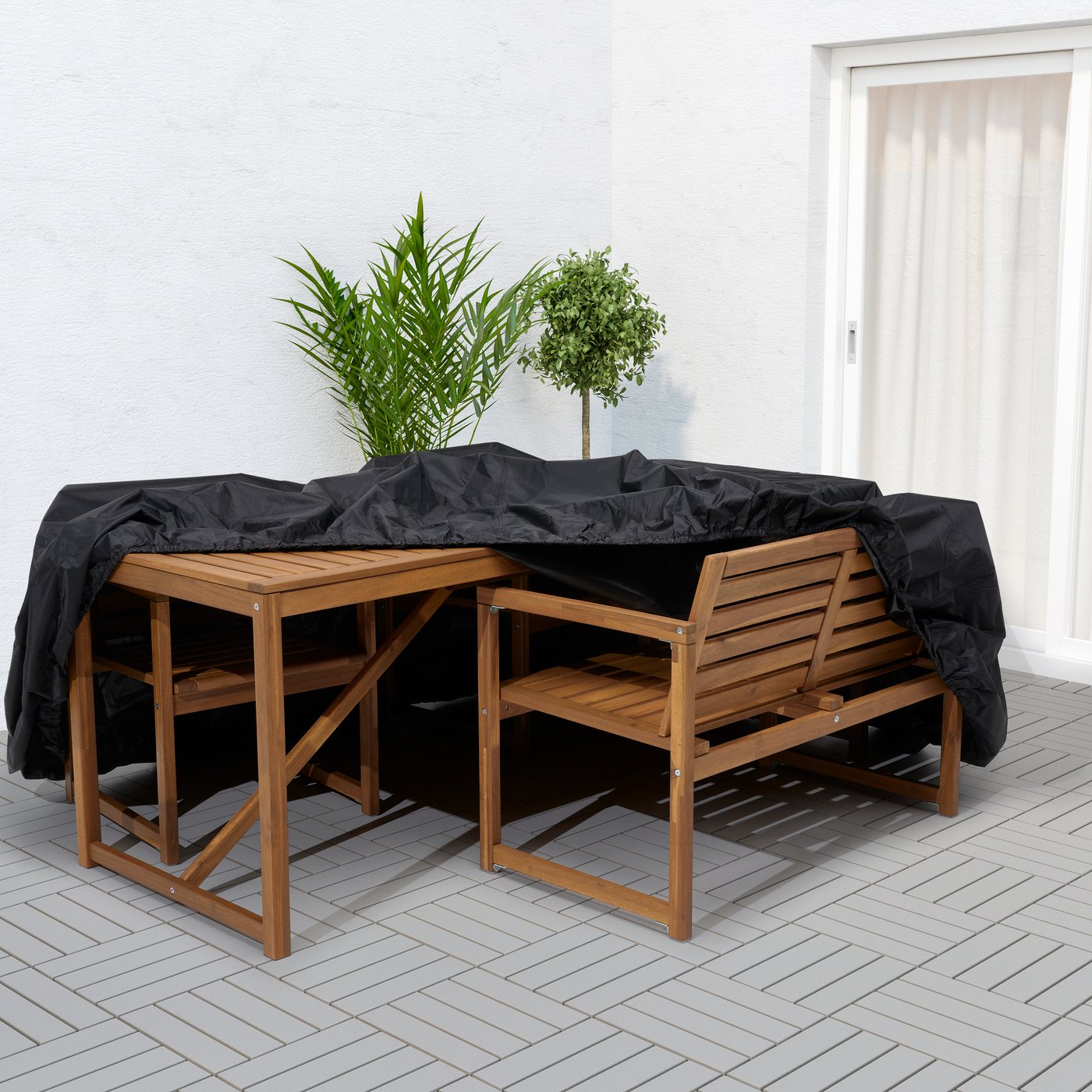 IKEA TOSTERÖ sofa/black cover for outdoor furniture, covering a NÄMMARÖ table with bench and chairs set. 