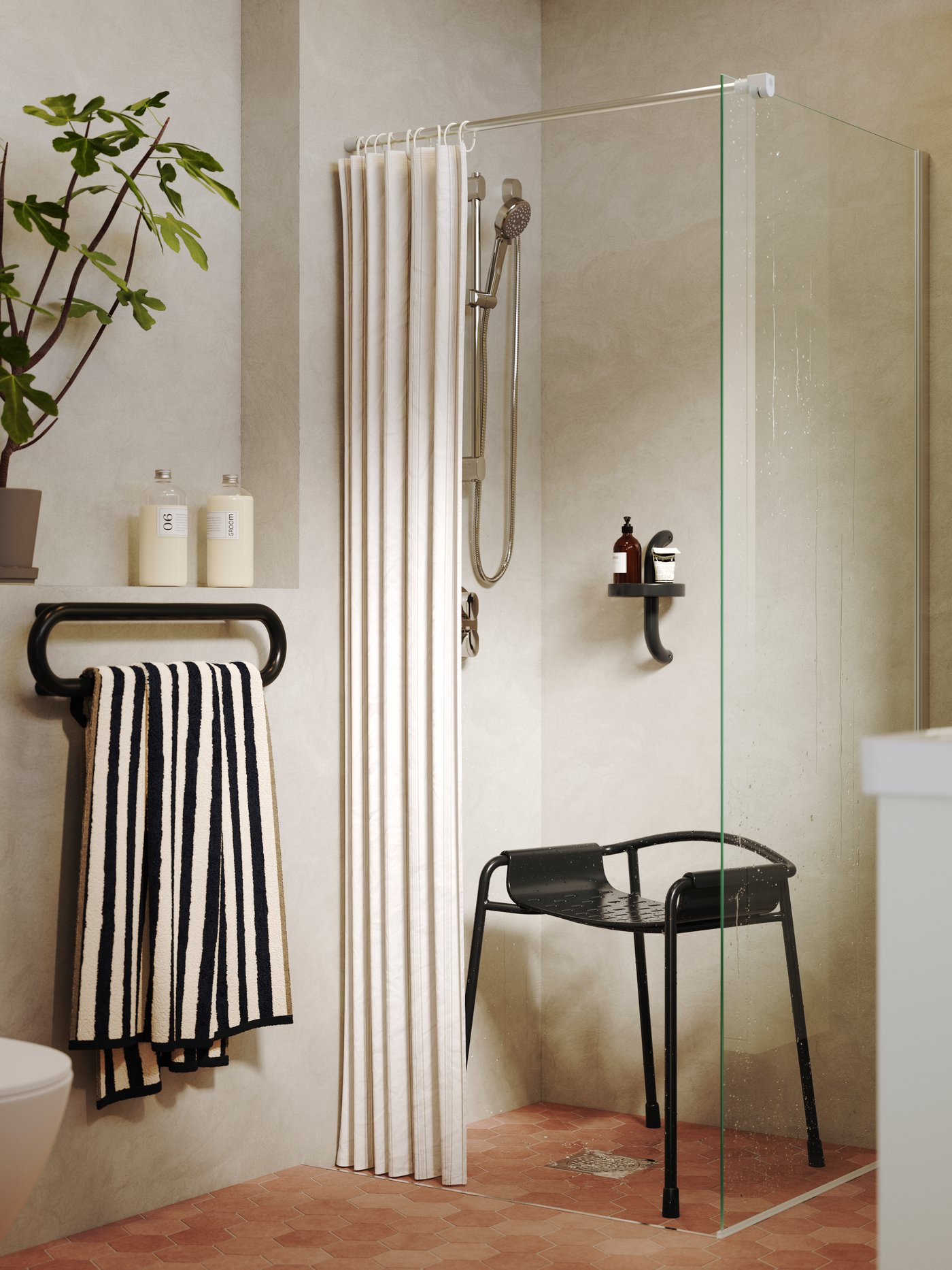 A BÄSINGEN shower chair in anthracite is placed in a shower and there’s a shower self and a towel rail with a striped towel.