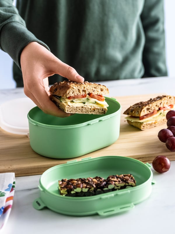A light green UTBJUDA stackable lunch box for dry food