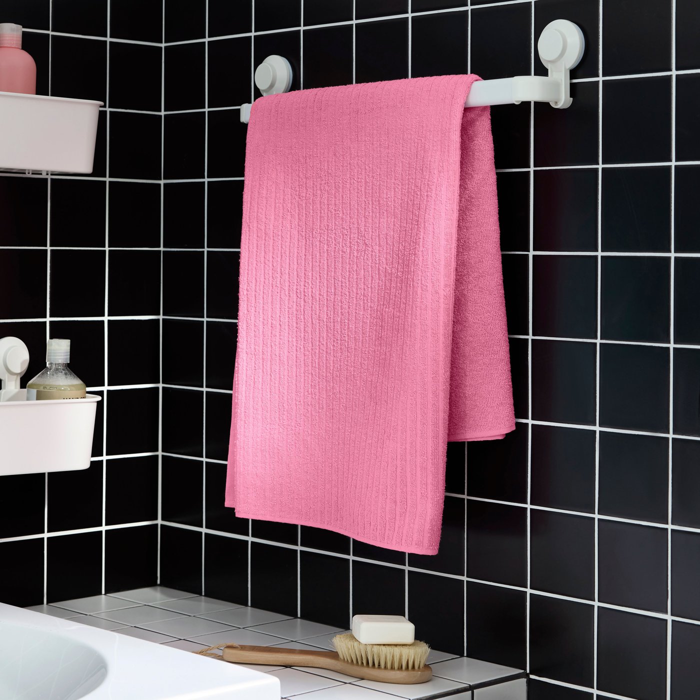 A white TISKEN basket with suction cup in the bathroom
