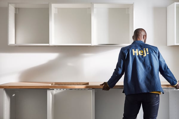 An IKEA kitchen installer installing a kitchen countertop.