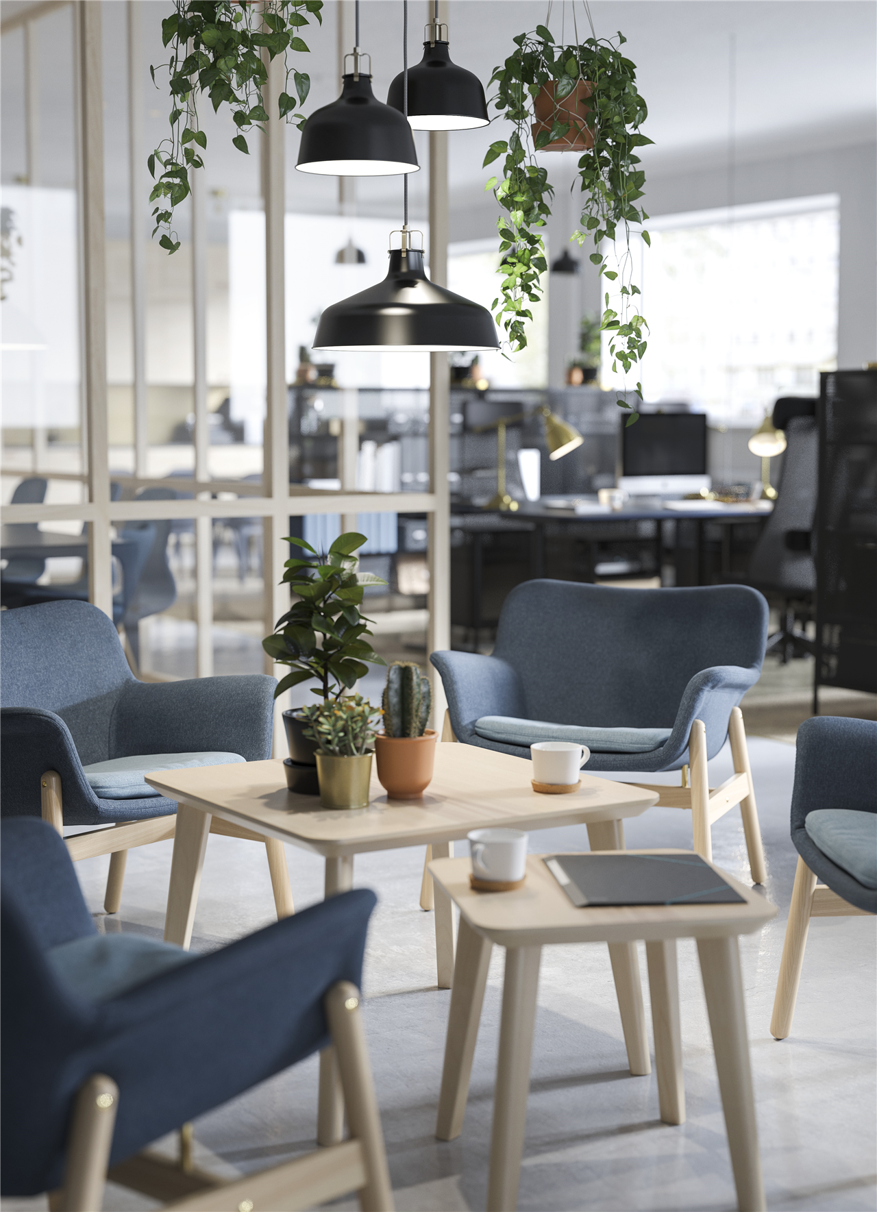IKEA FOTO pendant lamps, hanging plants, two tables and sloped blue chairs in a waiting area.