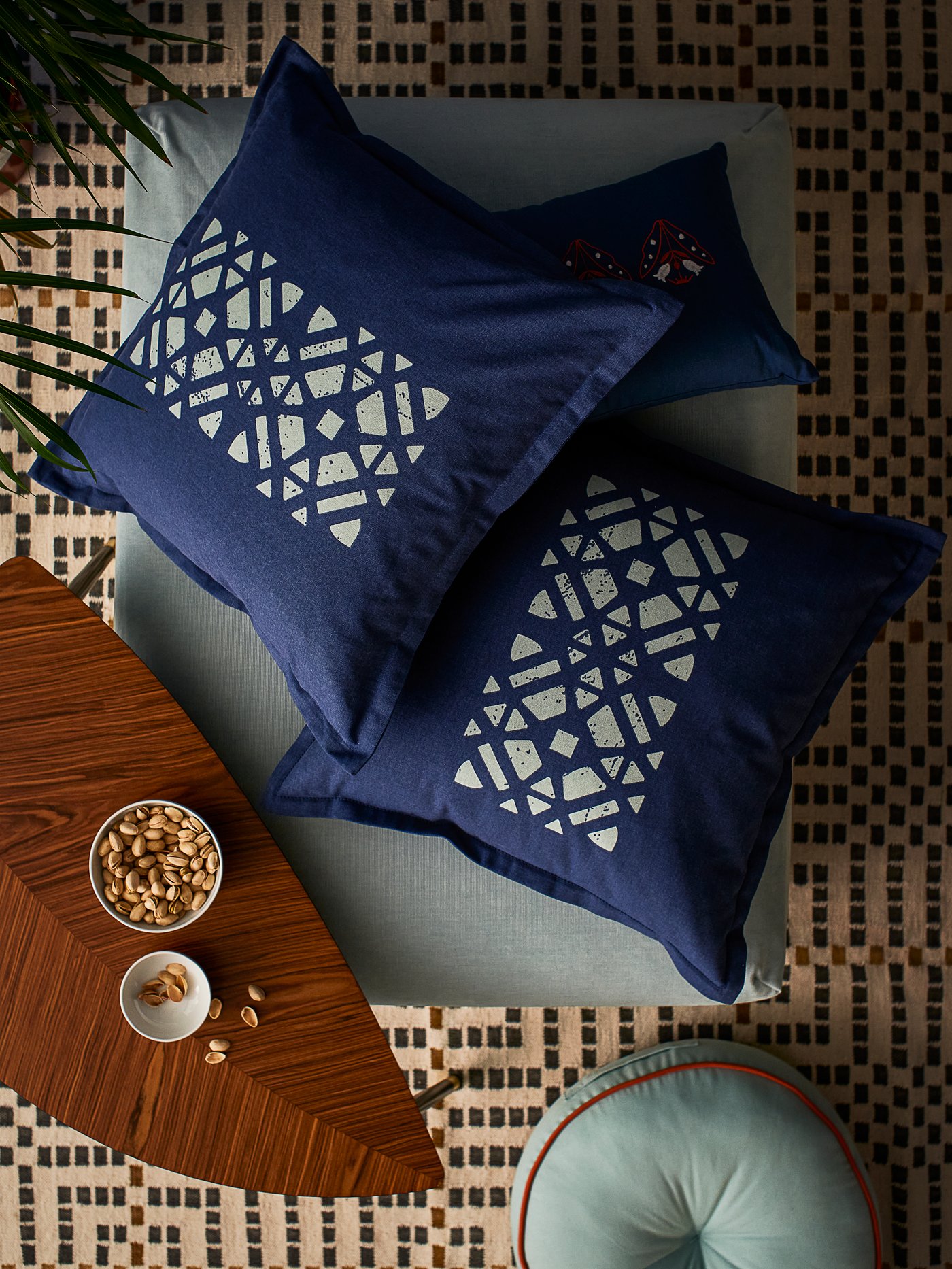 Tiga kusyen dalam sarung kusyen GOKVÄLLÅ di atas ottoman. Pada lantai di bawah ialah kusyen lantai GOKVÄLLÅ.