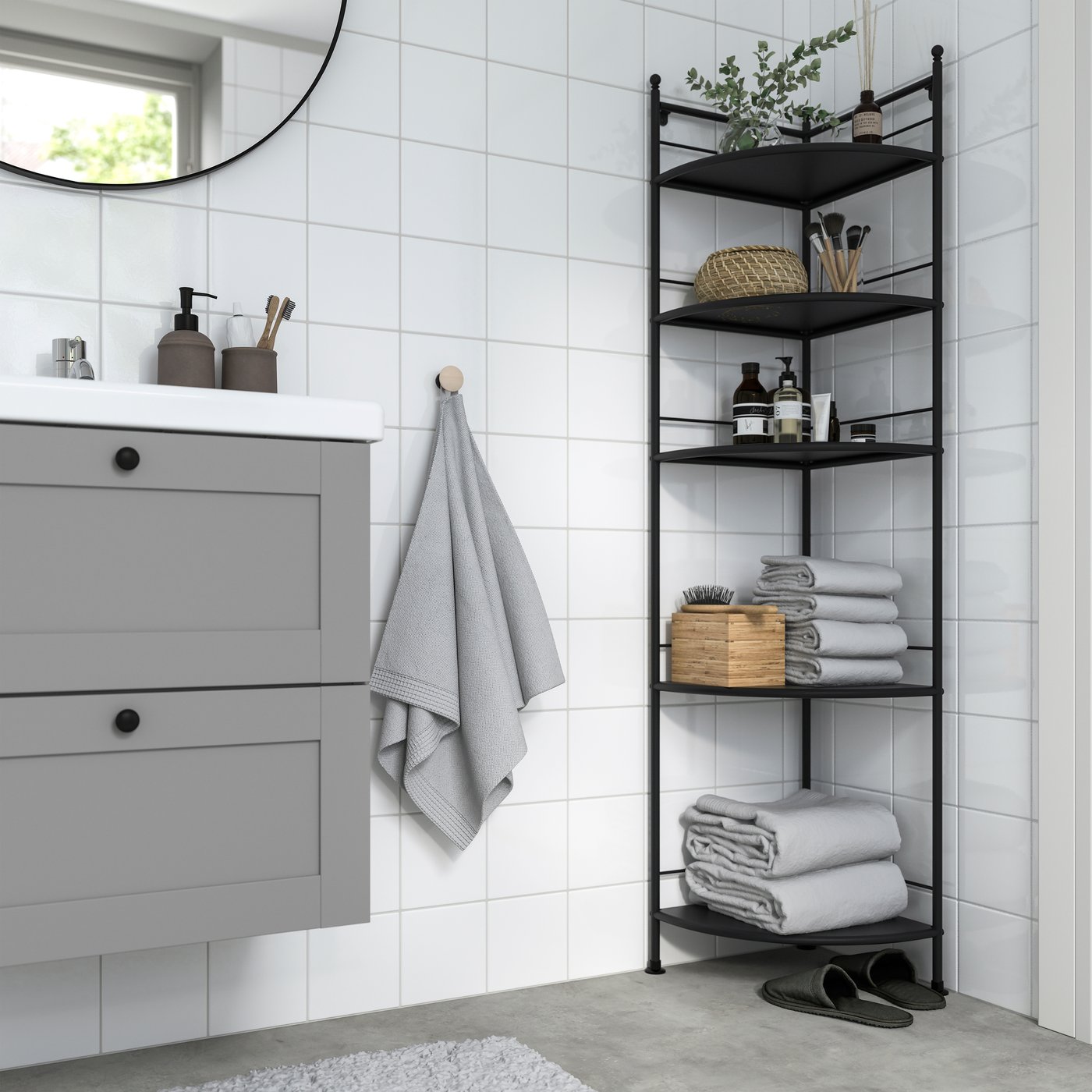 A black FRÖSJÖN corner shelf unit in the bathroom