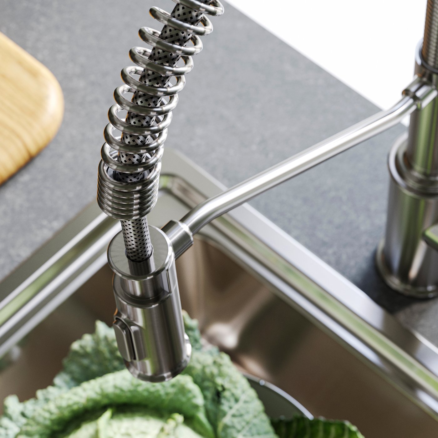 Close up image of a kitchen sink with TAKSJÖN kitchen mixer tap with pull down spray in stainless steel colour.