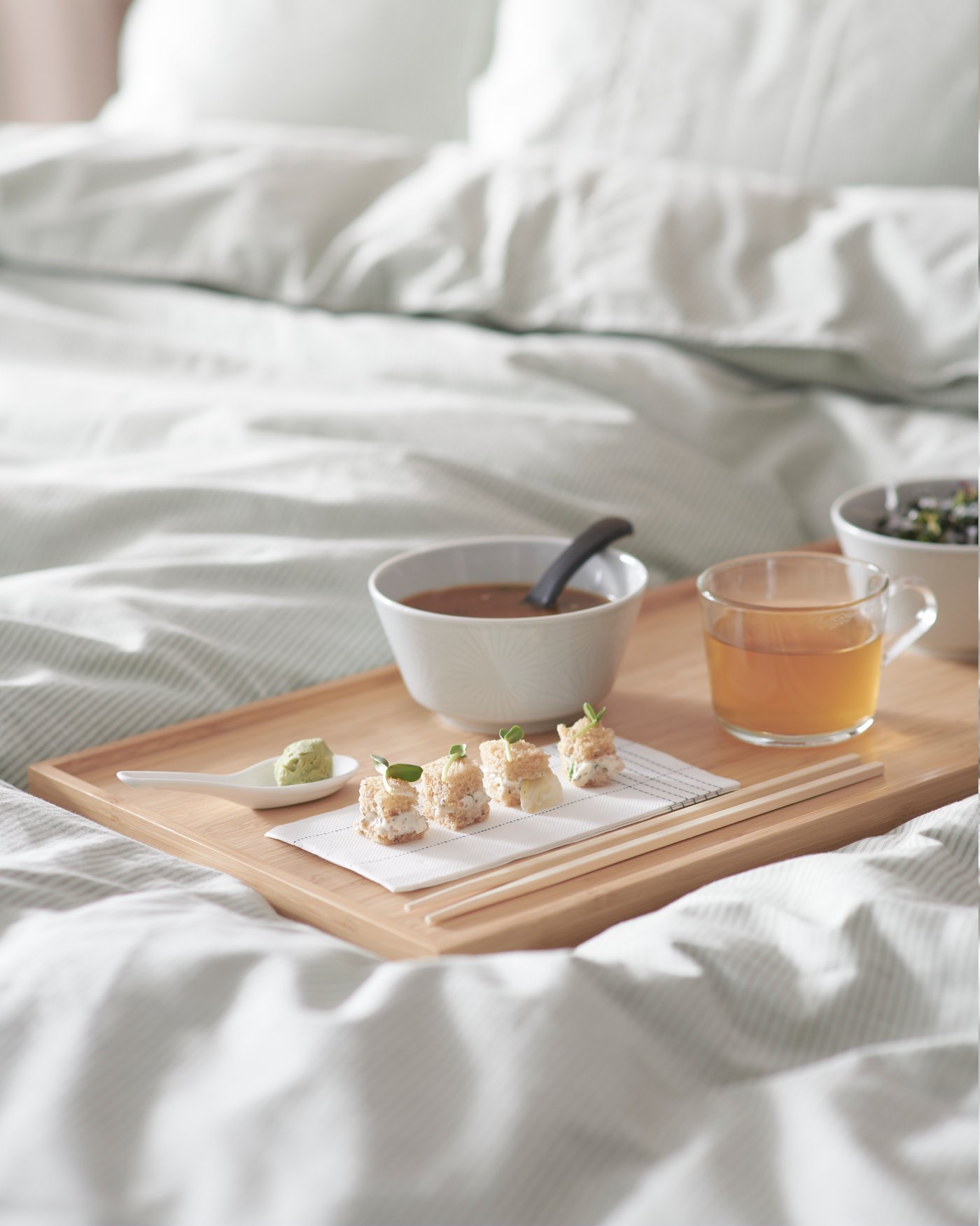 A clear glass IKEA 365+ mug in the bedroom