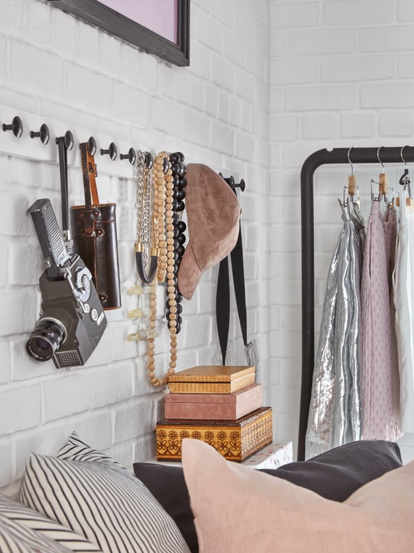 A black TURBO clothes rack, in/outdoor in the bedroom