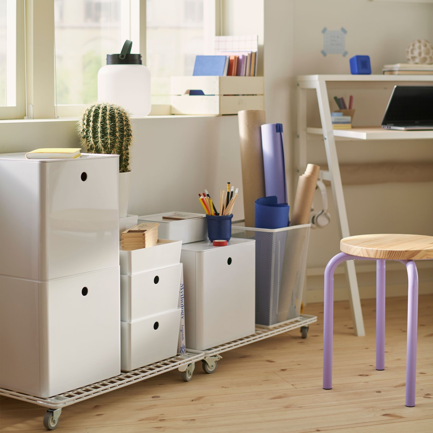 KUGGIS storage box with lid set on a shelf, surrounded by stationery and a desk.