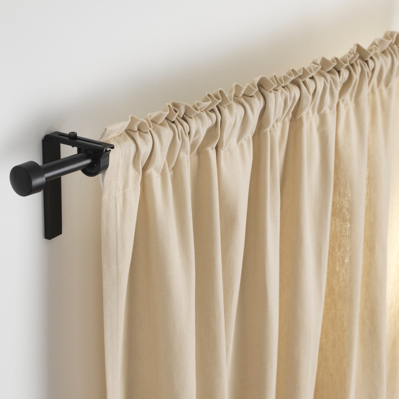 A black RÄCKA curtain rod combination in the NA