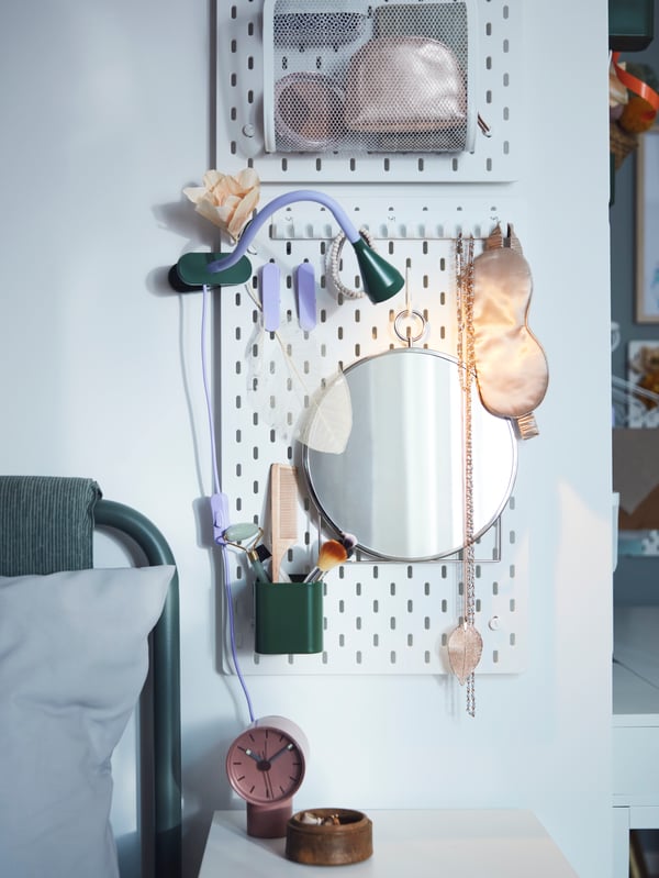 A silver-colour GRYTÅS mirror in the bedroom