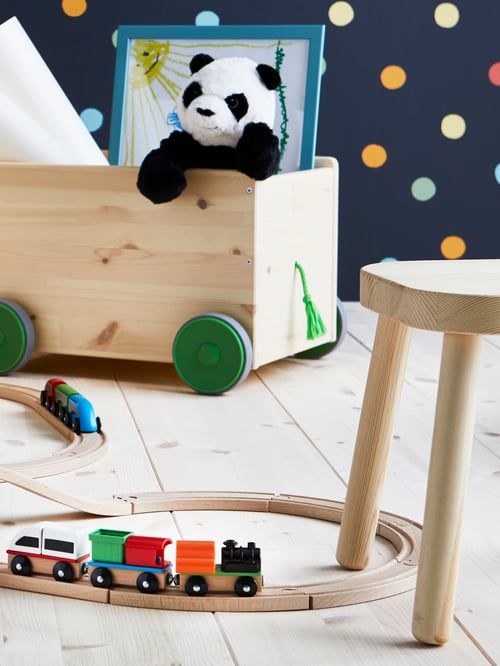 A LILLABO wooden train set with a train laid out on a wooden floor.