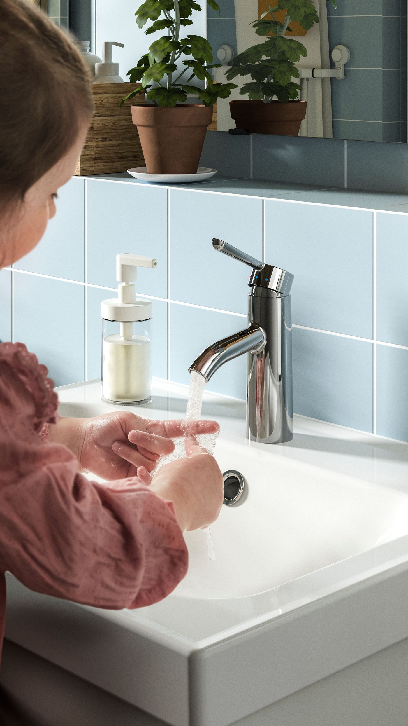 A girl is washing her hands in a white bathroom