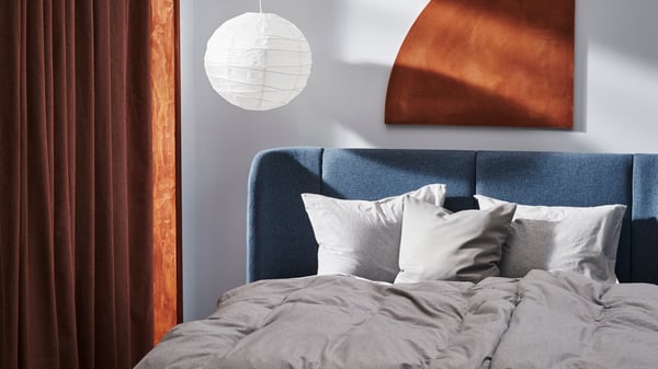 A Djuparp dark green TUFJORD upholstered bed frame in the bedroom