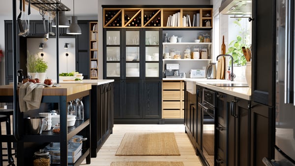 A large dark kitchen with kitchen counter and many details