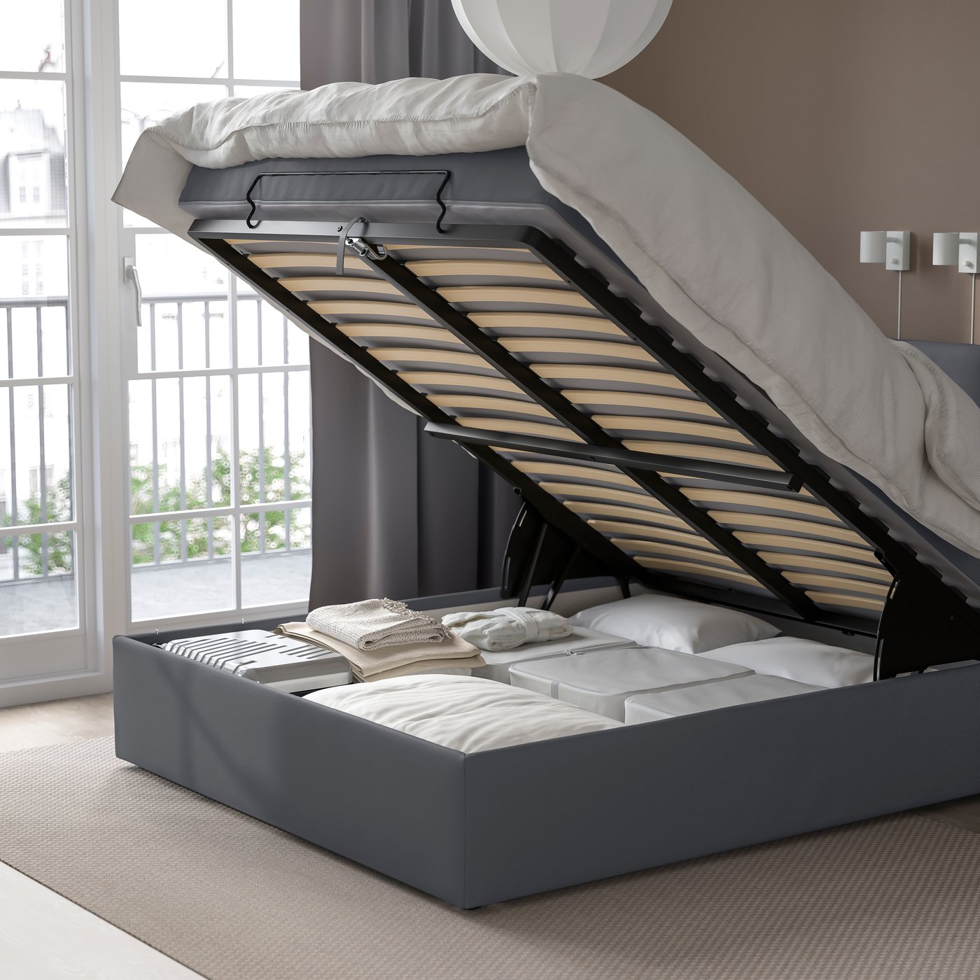 A medium firm/Kabusa dark grey BLÅFJÄLLET ottoman divan bed in the bedroom