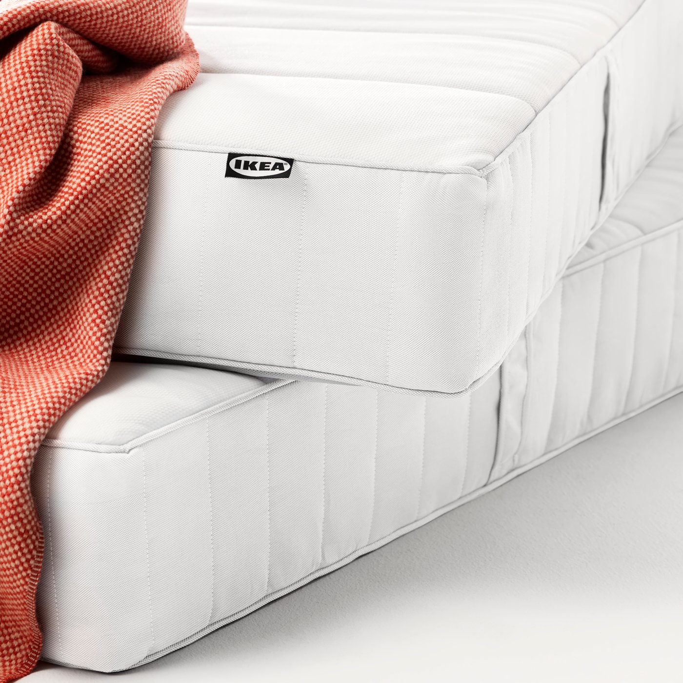 A firm/white ÅNNELAND hybrid mattress