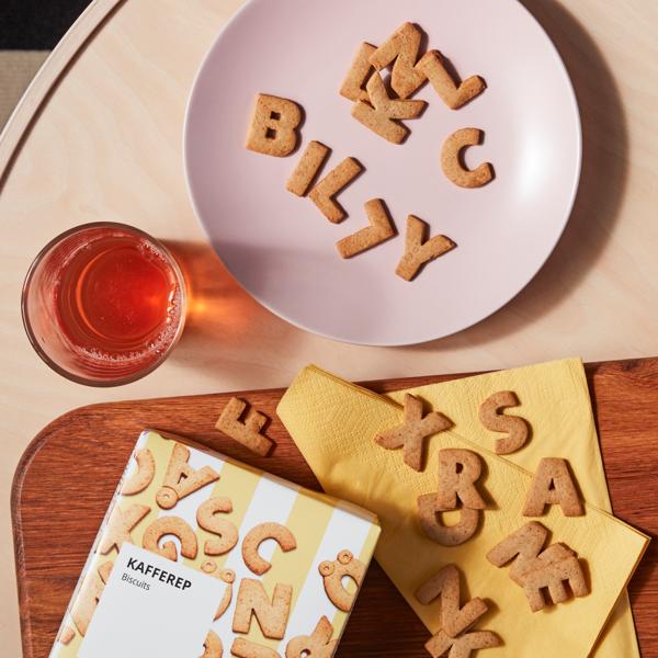 KAFFEREP letter shaped biscuits on a pink plate. 