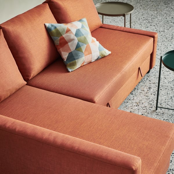 An orange/multicolour SVARTHÖ cushion cover