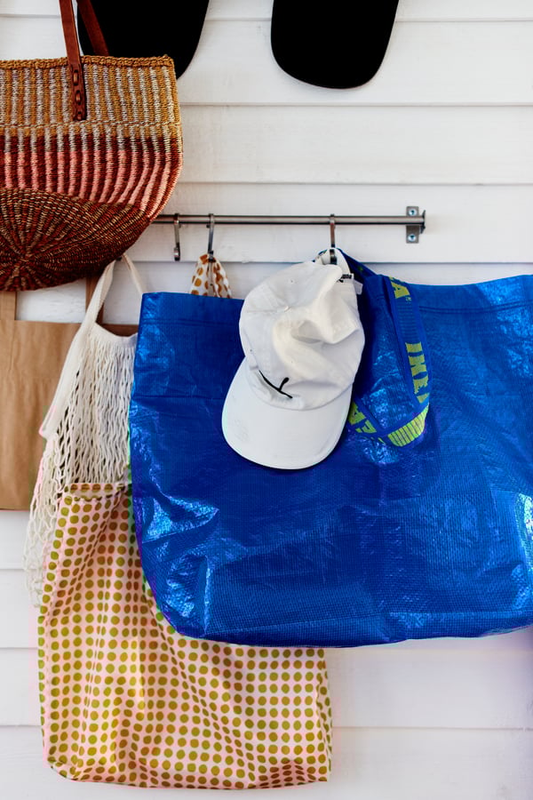 An yellow/white SKYNKE carrier bag in the hallway