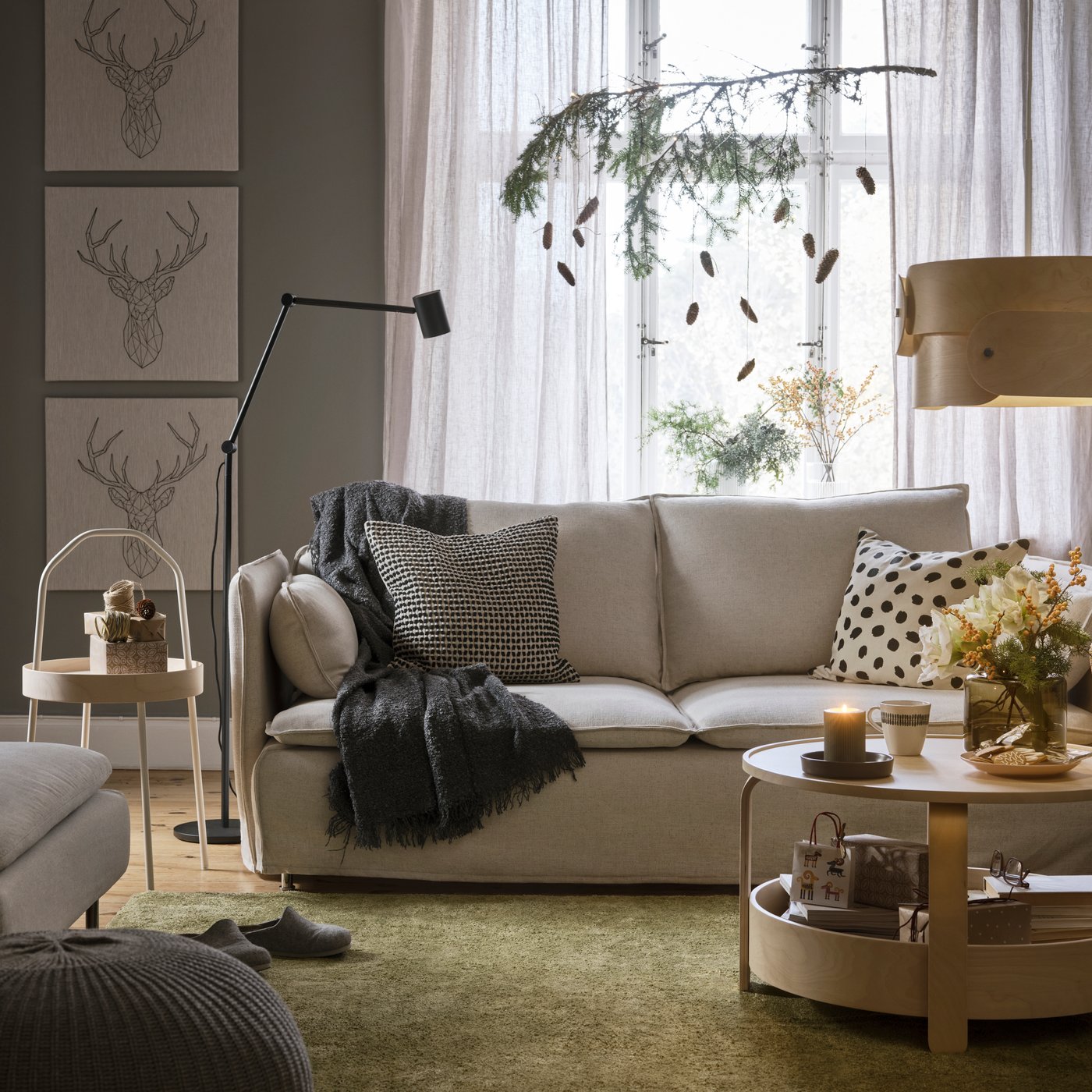 Vaalean oliivinvihreä, matalanukkainen STOENSE‑matto beigen SÖDERHAMN‑sohvan alla.