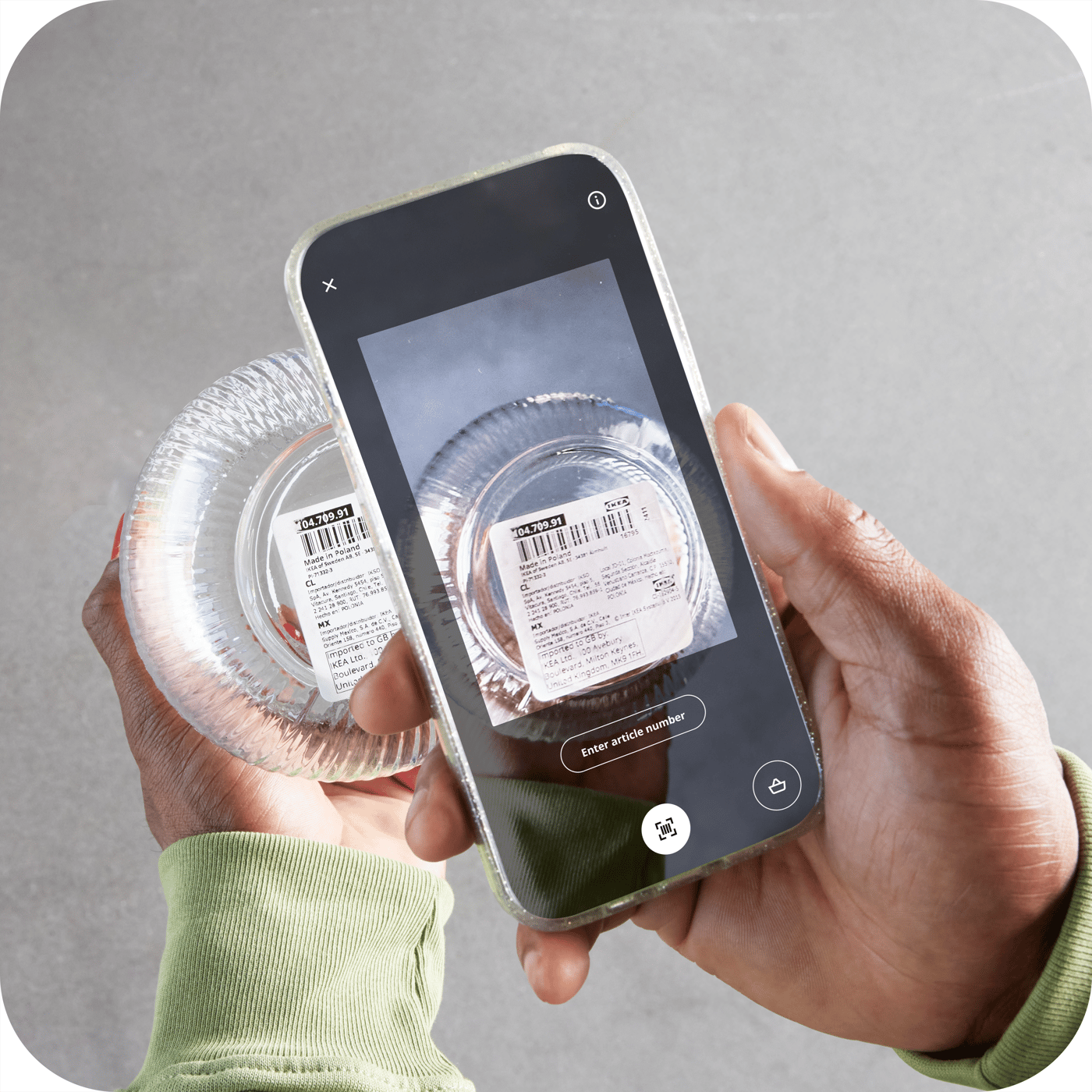 A person using the IKEA App on their mobile phone in a store.