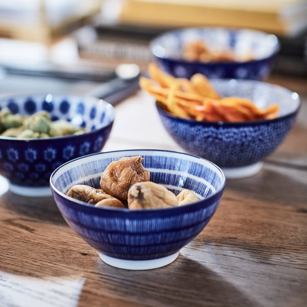 ENTUSIASM bowl with various patterns placed on a dining table containing delicious snacks and treats