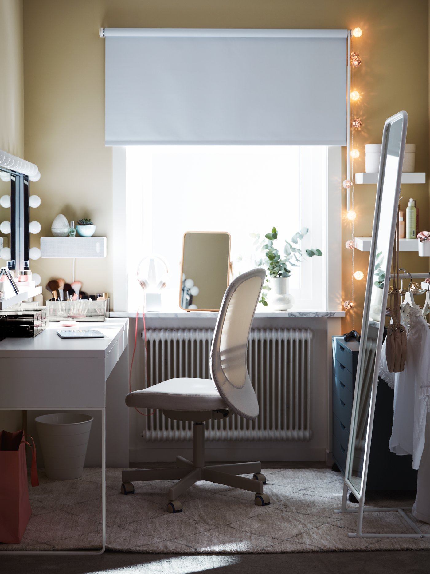 Bedroom space with a desk placed next to a bigh window