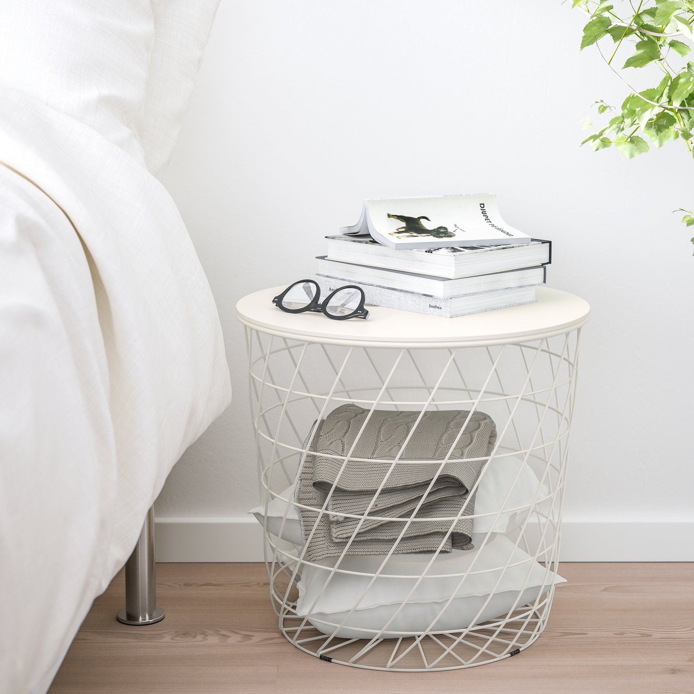 A white KVISTBRO storage table in the bedroom