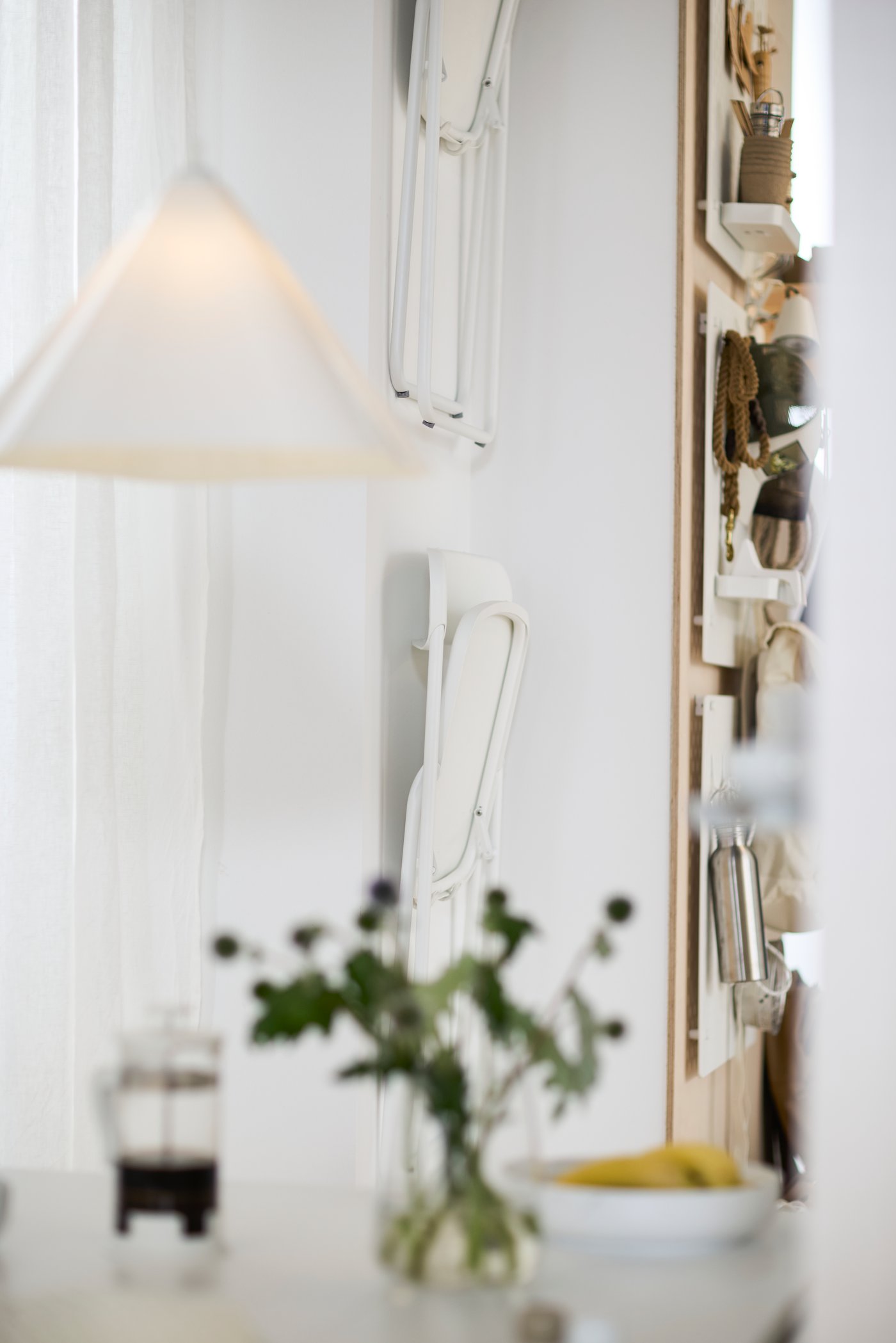 A white SKÅDIS pegboard in the dining room
