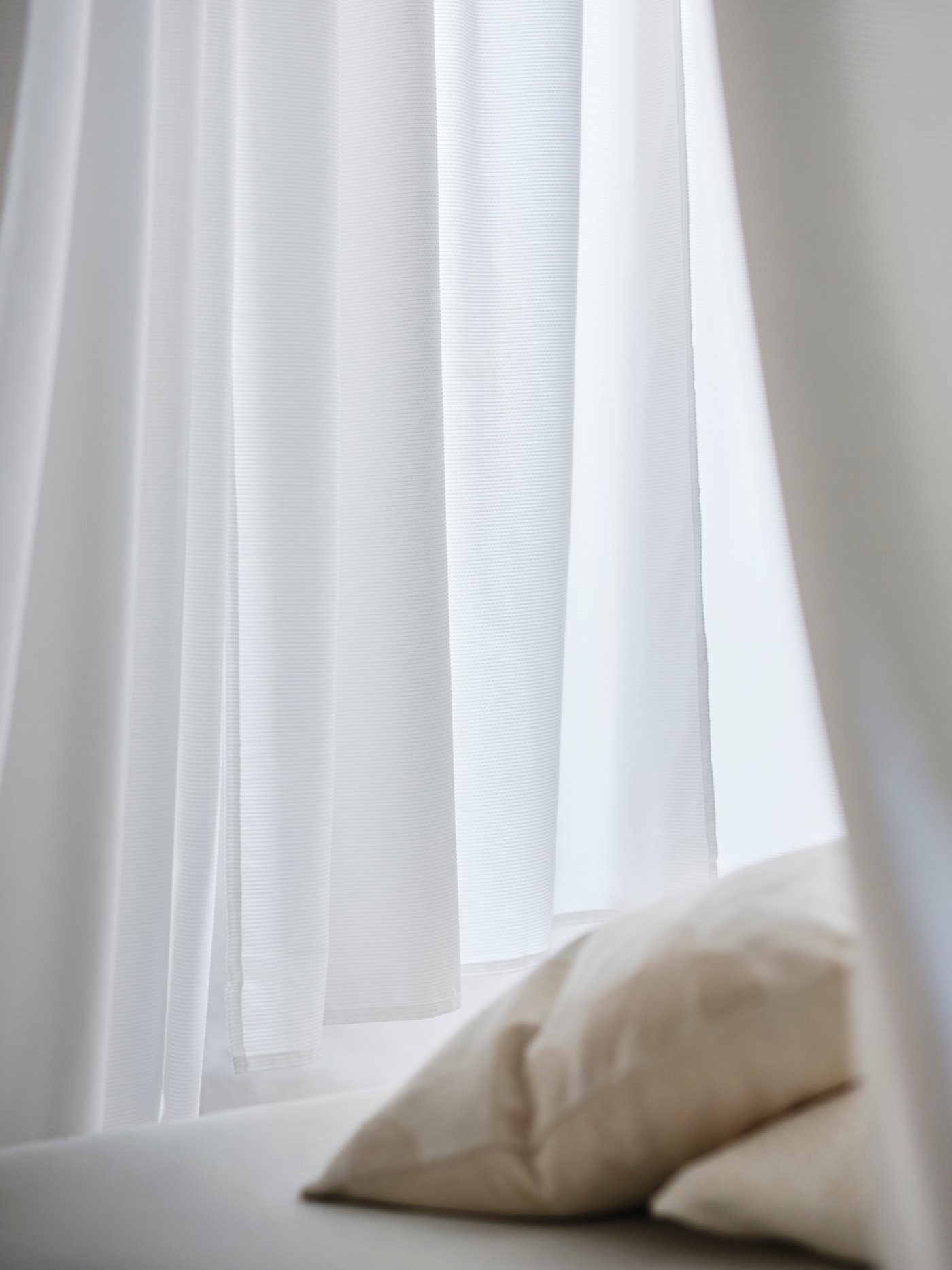 A beige RÖDASK cushion cover in the bedroom